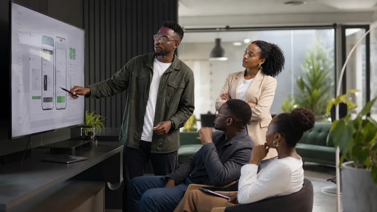 African software professionals reviewing a digital product with a business leader