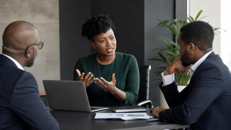 African cybersecurity consultant briefing business leaders in a meeting room